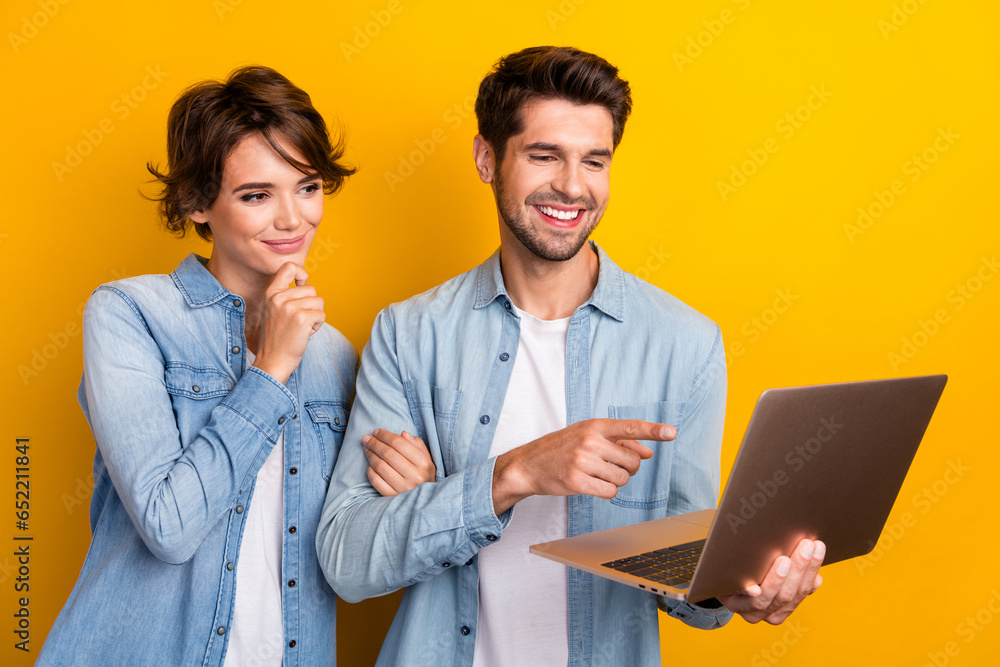 Poster Photo of two workers working netbook writing project pointing screen isolated bright color background