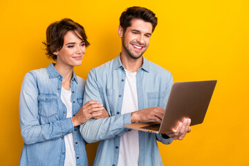 Photo of two freelancer lady guy browsing netbook chatting eshop website isolated bright color background