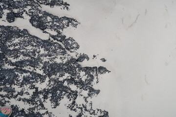 hardened volcanic lava on the sandy coast