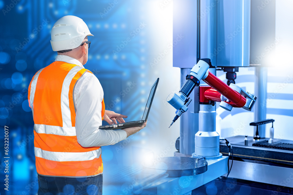 Poster man factory engineer. hand manipulator is controlled by laptop. robotic factory employee. programmer