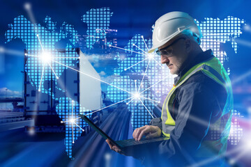 Logistics specialist. Male manager of transport company. Logistics company employee. Truck near man with laptop. World map is metaphor for international logistics. Transport dispatcher in hardhat