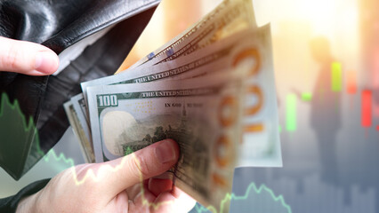 Money and wallet in hands. Cost reduction schedule. Concept of decreasing financial income. Dollar bills. Man hands with money. Economic background. Money for investment. Trading income