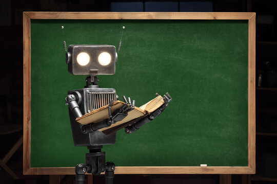 Humanoid robot with books at the blackboard. Classroom interior with educational subjects. Concept of the future of artificial intelligence and the 4th fourth industrial revolution.