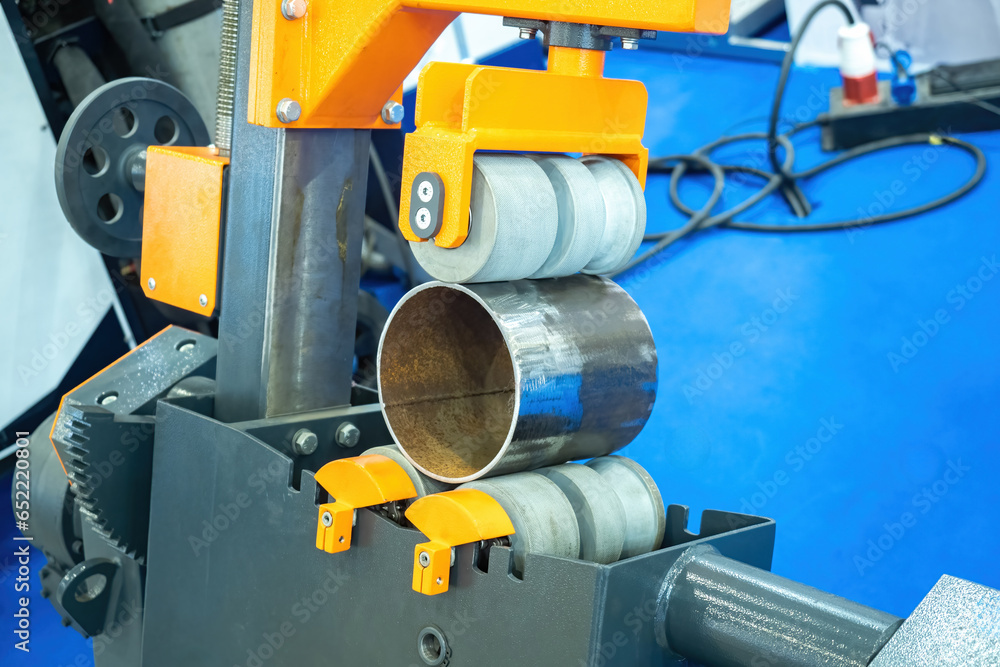 Poster pipe production. manufacturing pipelines for water or gas. pipe in middle of round rollers. fragment