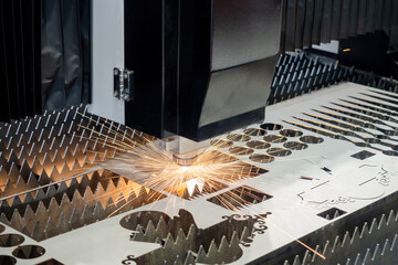 Laser cutting metal. Lathe in production. Modern metalworking equipment. Process cutting metal with...