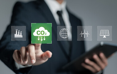 Reduce CO2 emissions concept, Businessman touch CO2 icon, reducing greenhouse gas emissions and sustainable development of green business using renewable energy. reduce carbon emissions. - obrazy, fototapety, plakaty