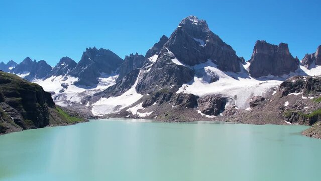 Beautiful drone footage of a Lake surrounded by the peaky mountains in the Himalayan region of Kashmir - Chitta Katha Lake.