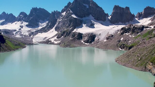 Beautiful drone footage of a Lake surrounded by the peaky mountains in the Himalayan region of Kashmir - Chitta Katha Lake.