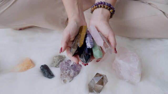 Woman hands showing Various crystal towers quartz gemstones point different colors in lotus position for meditation and holistic relaxation rituals Harmony life balance.