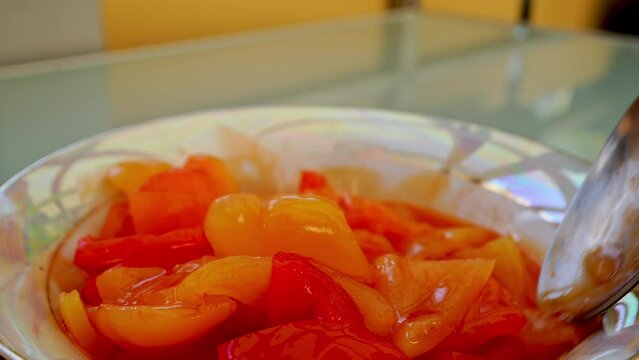 Lecho with fresh peppers, stirred with a spoon. High quality 4k footage