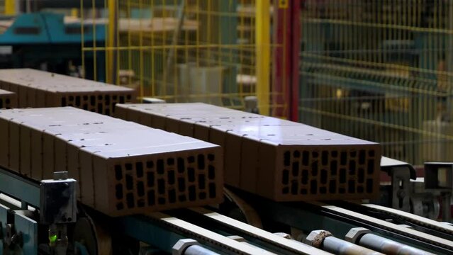 Clay bricks moving on conveyor at brick factory