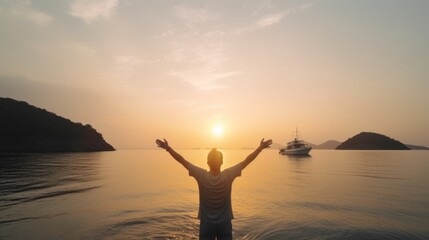Fototapeta premium Silhouette of woman with arms outstretched enjoying the sunset on the beach.