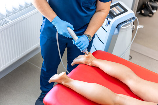 Patient getting non-surgical treatment with shock waves for plantar fasciitis.