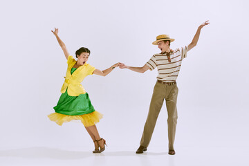 Emotional, happy, beautiful young couple, man an woman dancing isolated on white studio background....