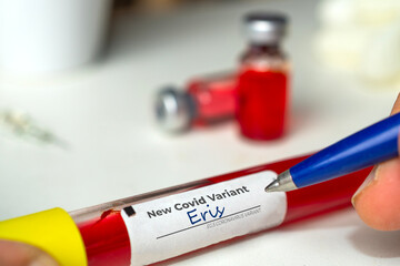 Doctor labels a vial of coronavirus variant Eris