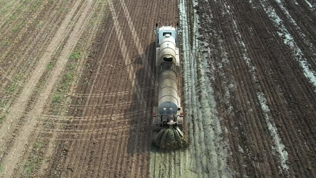 A tanker spreads liquid manure on a Wisconsin farm field recently harvested of corn silage.