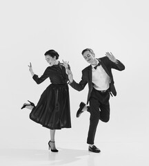 Rhythmic. Black and white. Stylish, elegant young couple, man and woman in stylus clothes dancing....