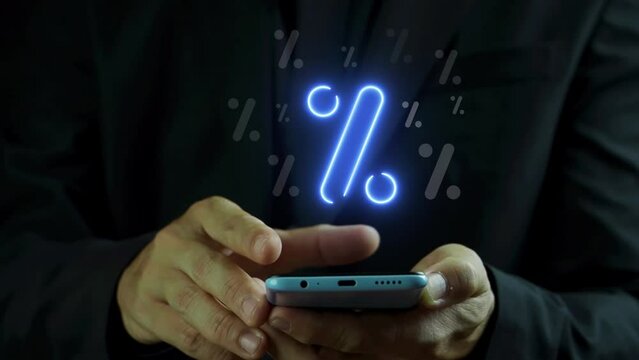 Businessman hand using smartphone with percentage icon. Profit high growth percent icon, stocks, financial, ranking, mortgage rates, Interest rate and dividend concept.