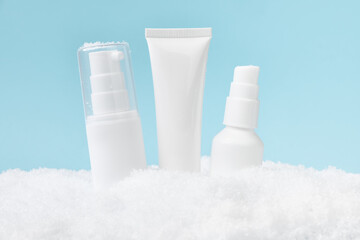 Winter skin care. Cosmetics products in the snow.