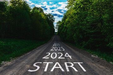 New year 2024 or straight forward concept. Text start year 2024, 2025,2026 written on the road in the middle of road with at sunset. Concept of planning, goal, challenge, new year resolution.Toned. - obrazy, fototapety, plakaty