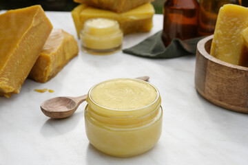 A jar of natural, organic  ointment made from fresh beeswax. 
