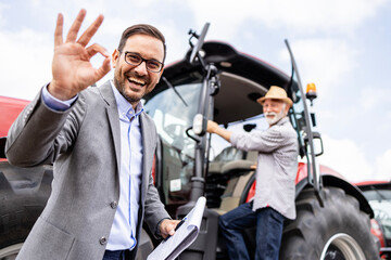 Portrait of professional salesman selling agricultural machines and farming equipment.