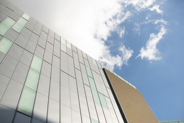 Low angle looking up at tall corporate glass building
