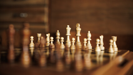 Wooden chess board with set of chess pieces on table. Selective focus