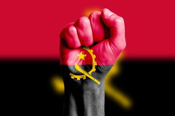 Man hand fist of ANGOLA flag painted. Close-up.