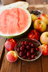 Delicious summer fruits on wooden table