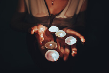 Woman swimming in pool with candles