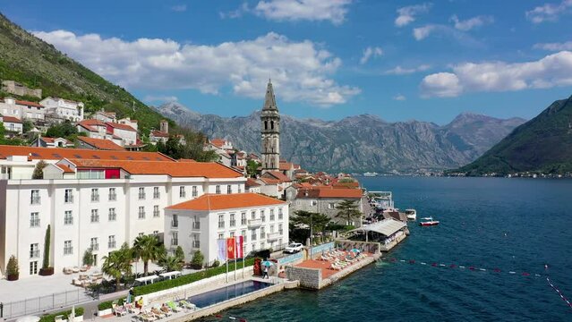View of the historic town of Perast at famous Bay of Kotor on a beautiful sunny day with blue sky and clouds in summer, Montenegro. Historic city of Perast at Bay of Kotor in summer, Montenegro.