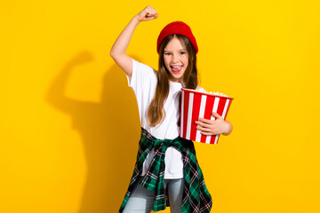 Photo portrait of charming schoolgirl raise fist eat popcorn premiere dressed stylish white garment...
