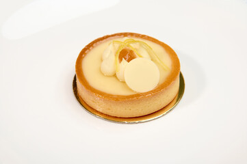 Still life with French sweet dessert a lemon cake, isolated over white background