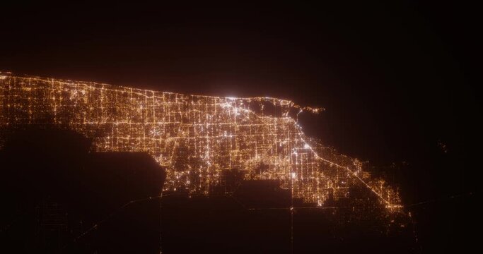 Miami (Florida, USA) top view at night. Aerial view on modern city from space. Camera is flying above the city, moving forward. Vertical video. The north is on the left side
