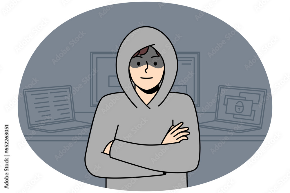 Poster young man in hood standing near computers hacking internal operations system. suspicious male hacker