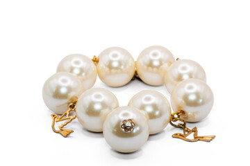 old bangle bracelet made from pearl color plastic and  gold metal isolated on  white background,macro photo,has path