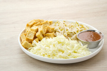 Tahu Campur, made from tofu, cabbage and bean sprouts served with peanut sauce. Indonesian traditional food
