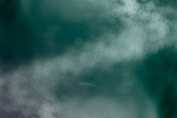 Abstract mist smoke  blurred  bokeh glitter light effect on nature green background. Ideal for wallpaper, online post, web title, presentations more use.