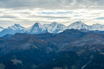 Breathtaking view of the Bernese Oberland mountains in Switzerland with a dramatic cloudy sky