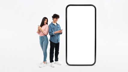 Couple Near Huge Smartphone Using Their Cellphones On White Background