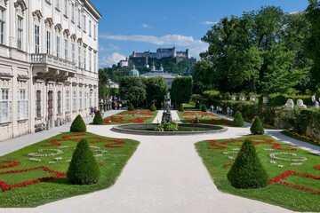 White building of Mirabell Palace and green garden