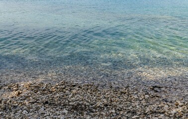 Closeup shot of a rocky coast with calm blue water - great for backgrounds