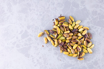 concept of roasted pistachios. pistachios line-up on white countertop