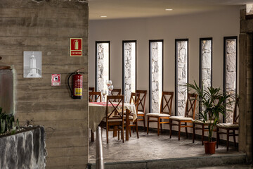Interior of a luxury restaurant with rows od wooden chairs and tables - obrazy, fototapety, plakaty