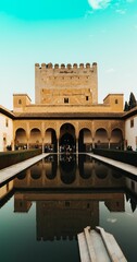 Fototapeta premium Alhambra Palace in Granada, Spain with tourists' reflection on water