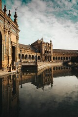 Maria Luisa Park with an captivating building reflected in water surface