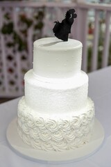Classic white wedding cake set atop a pristine white tablecloth