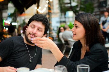 Hot couple in the outdoor cafe enjoying their morning coffee