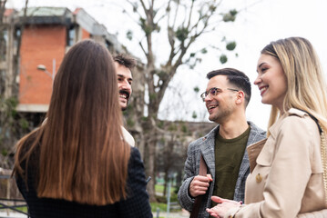 Group of business people walking outside in front of office building. Colleagues discussing on the...